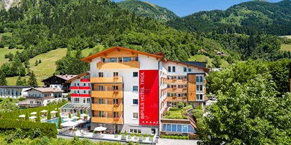 Wellnessurlaub - Wassergymnastik - Hüttschlag - Aussenansicht Sommer - Impuls Hotel Tirol