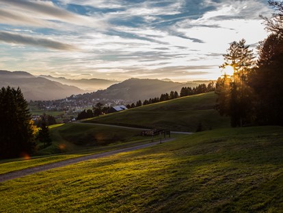 Wellnessurlaub - Aromamassage - Grän - Das herbstliche Naturresort von oben mit Blick über Oberstaufen. - Haubers Naturresort