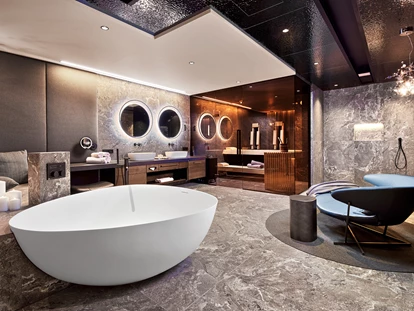 Wellnessurlaub - Private Spa - Otterbach (Sankt Florian am Inn) - Badezimmer der Luxury-Suite mit eigener Sauna, freistehende DUO-Badewanne mit Regensystem, 
Wärmebank und Relax-Bereich - 5* Wellness- & Sporthotel Jagdhof